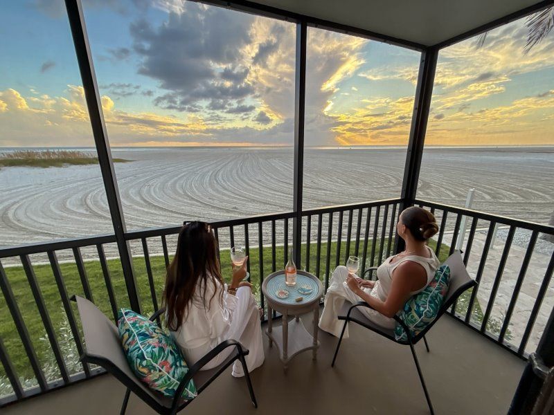 women enjoying a glass of wine on the balcony of Fort Myers Beach condo rental