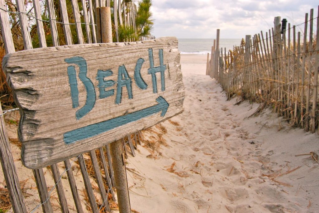 sign pointing to the beach